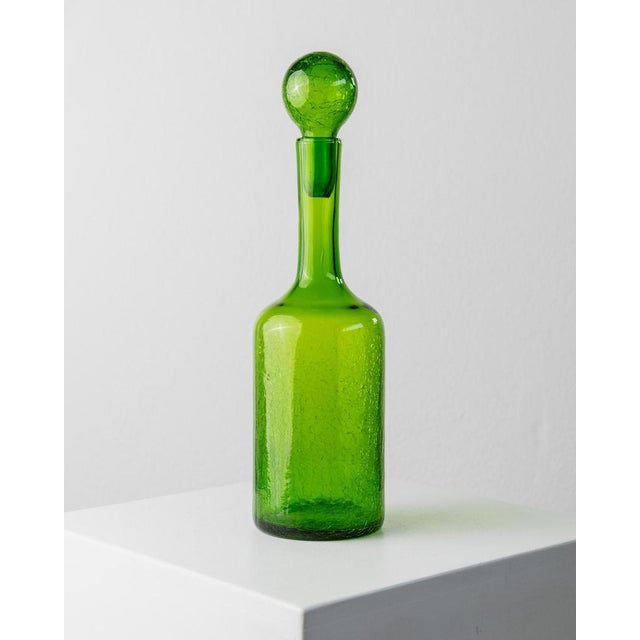 This vintage Murano glass set from the 1960s includes three glasses and a matching decanter in a vibrant green hue with a...