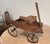 A late 20th century miniature handcrafted decorative oak wagon model with a raised bench seat, wooden spoked wheels and an...