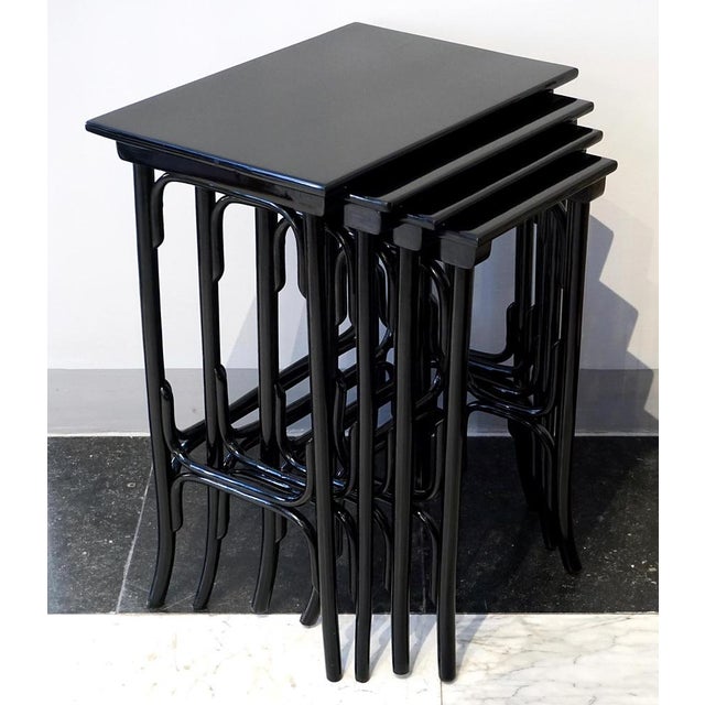 An elegant art nouveau side table set comprising four individual tables of varying sizes that can be nested inside one...