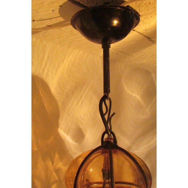 Two identical lanterns, shape and size, large: 50 cm in blown glass in wrought iron arabesque cage. Large screw base....