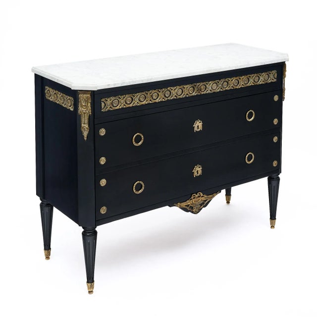 Chest of drawers in the Louis XVI style from France. This piece has been ebonized and finished with a lustrous museum-...