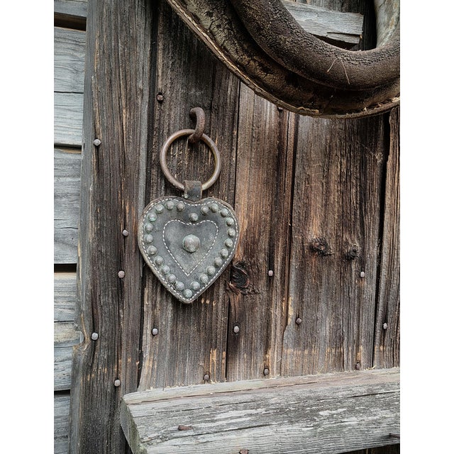 "The heart-shaped leather tack decoration hanging from the collar front is original harness hardware — not an addition. It...