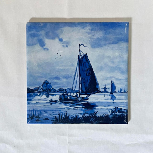 A peaceful nautical vista in crisp blue & white shades showing a serene landscape through which sails a pair of small open...