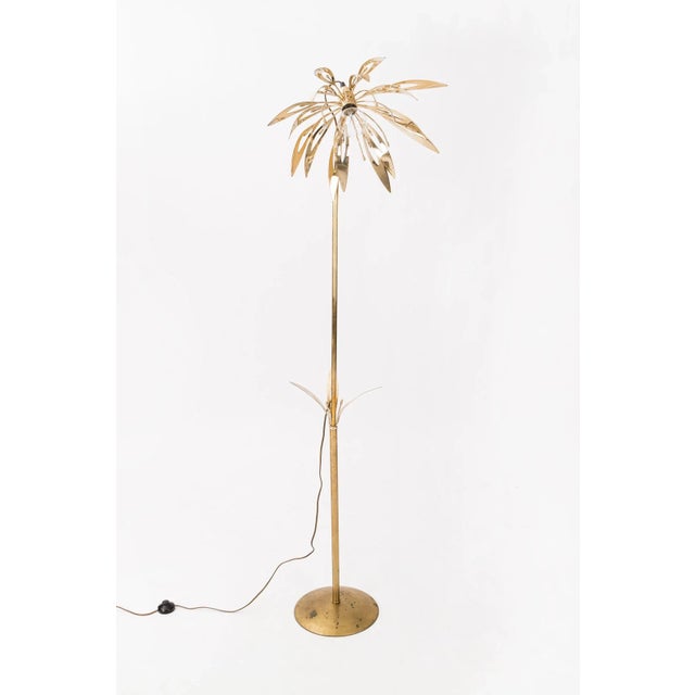 Polished brass palm tree floor lamp, on a heavily patinated round base, inspired by the work of Gabriella Crespi....
