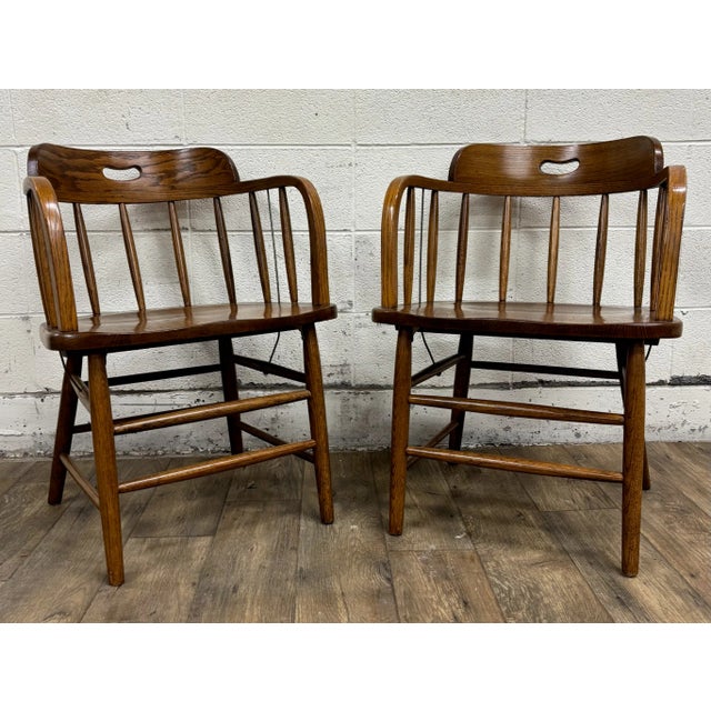 This is a pair of beautiful antique barrel back oak pub chairs or captain’s chairs, likely from the late 1800s or early...