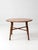 Vintage round wood table with a plank-style top, turned legs, and simple stretcher base inspired by early American...