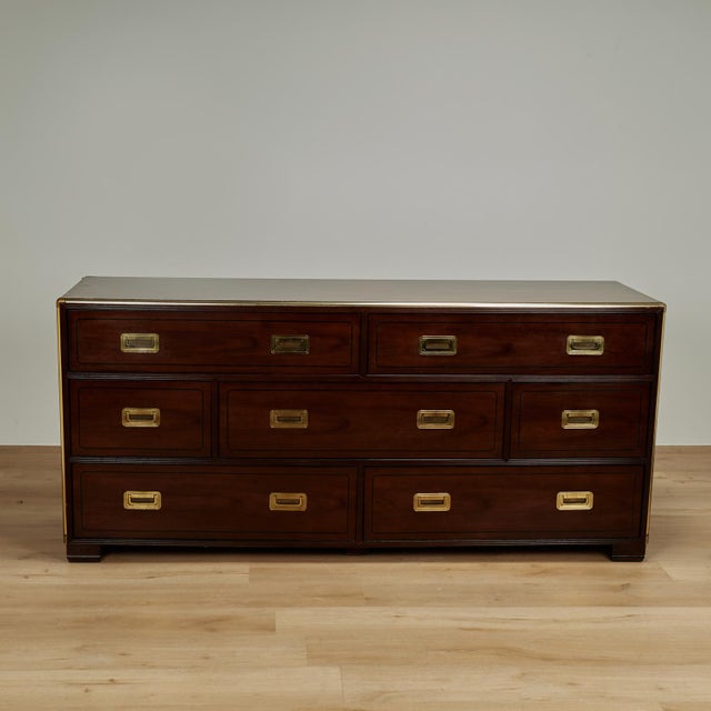 Handsome vintage campaign style chest crafted in mahogany with seven off set drawers, brass hardware and banding over...