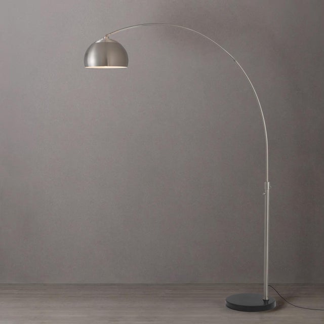 The Half Dome Arc Lamp is a modern arc lamp designed by Peter Morelli in 1960, featuring a sweeping silhouette and a satin...