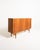 Teak highboard with oak trim, three hinged doors, and two central drawers with shaped handles. Scandinavian production,...