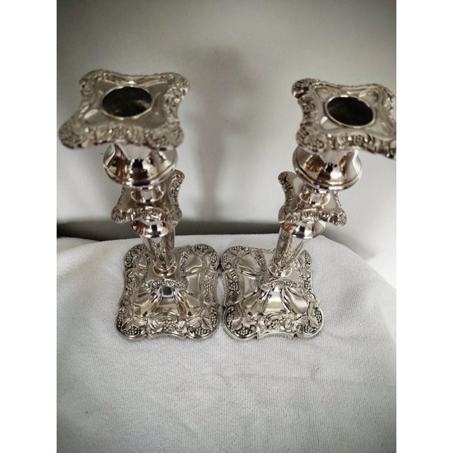 Description This is a pair of antique decorative candlesticks. An English, silver plated candle sconce, dating to the...