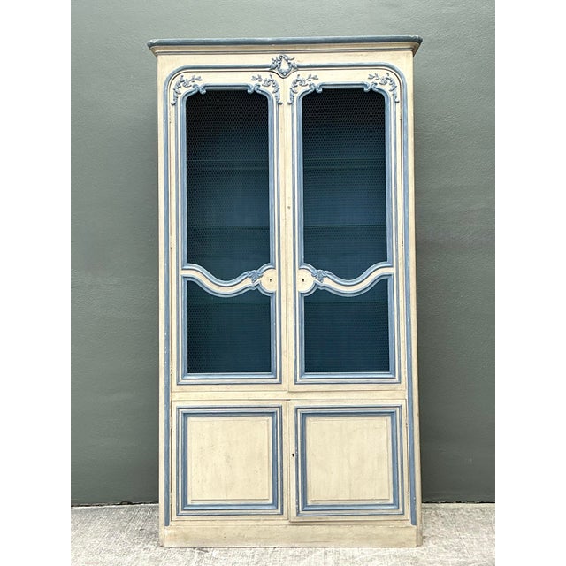 This exceptional vintage armoire by Baker Furniture epitomizes the timeless charm of French Provincial design. Crafted...