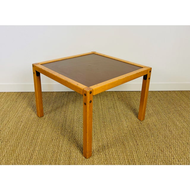 A charming coffee table with a minimalist design, typical of scandinavian furniture from the 1960s and 70s. it features a...