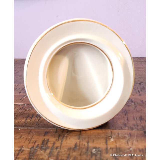 This is a pair of vintage 1980s ivory porcelain with gold trim table top picture frames. Measures 5.5 inches diameter with...