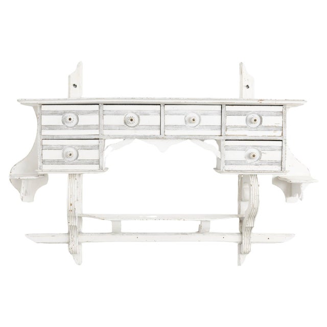 Indulge in the quaint charm of this 1910s Belgian kitchen wall shelf, thoughtfully designed for both practicality and...