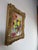 A charming vintage floral still life oil painting featuring a vibrant bouquet of blooming flowers arranged in a vase. Rich...