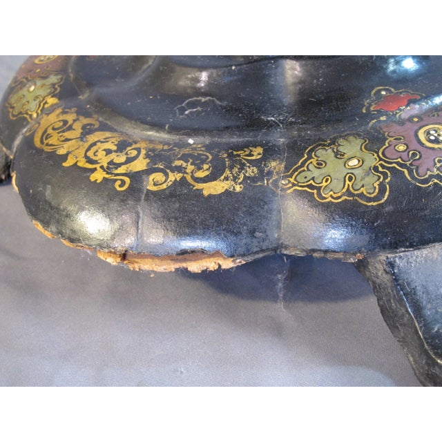 A Papier mache lacquer hand painted and pearl inlaid table circa 1880’s features a tilt top.
