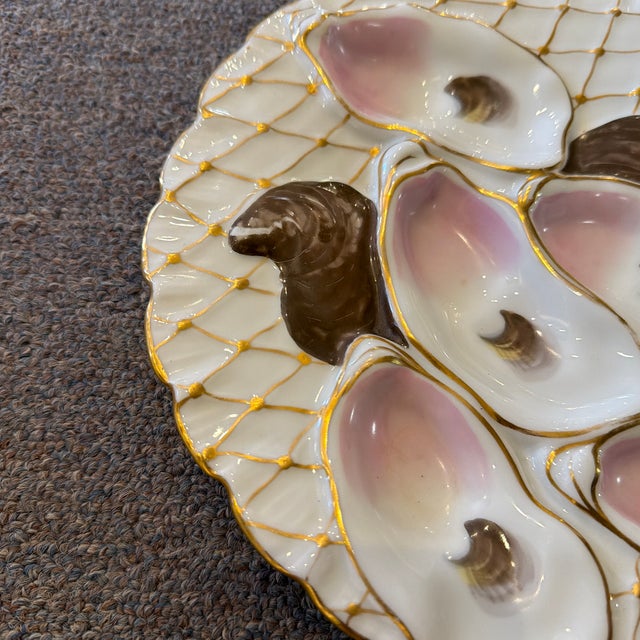 distinctive gold fishing net or lattice pattern, which is intended to make the oysters look as though they have been...