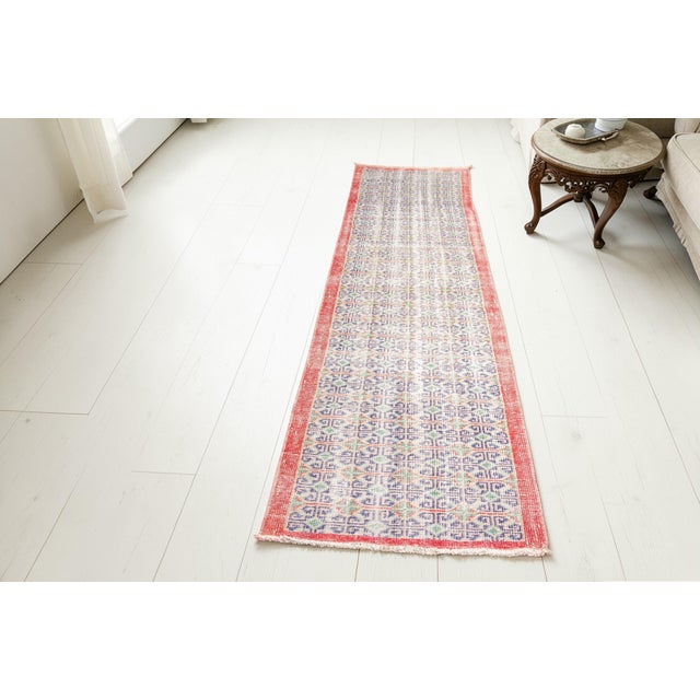 This is a vintage Turkish Oushak rug from the Mid 20th Century. The piece was hand-knotted.