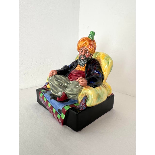 This stunning Royal Doulton "Abdullah" HN 2104 figurine is a true work of art, showcasing the vibrant and intricate...