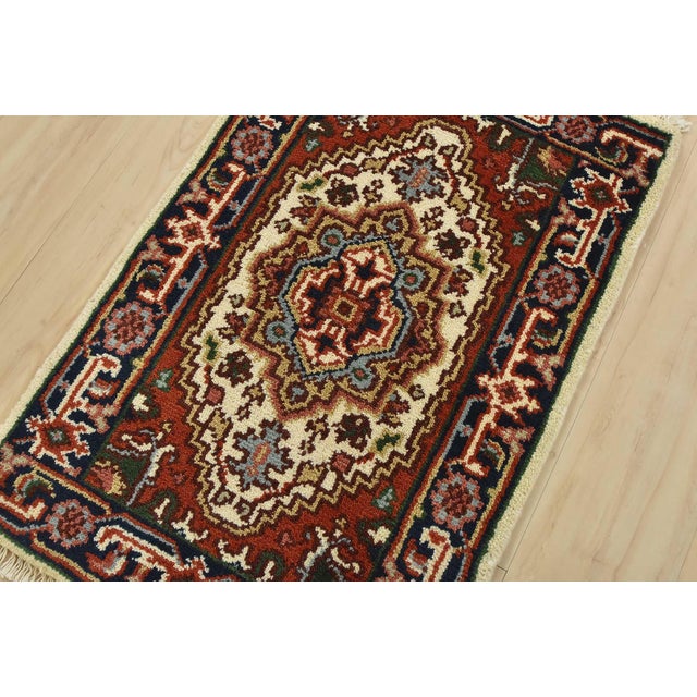 A traditional tribal Heriz rug hand-knotted with fine wool on a cotton foundation. This oriental rug features a central...