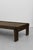 Low coffee table constructed from solid wood planks with a warm, timeworn finish. Defined by a thick rectangular top,...