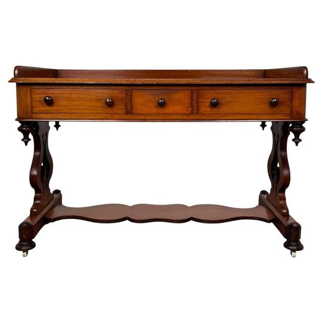 A handsome 19th-century English side table, finely crafted from mahogany and distinguished by its elegant proportions,...