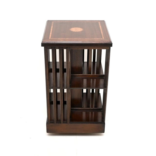 A stylish and useful antique Sheraton style inlaid revolving bookcase, dating from around the 1930-50’s period. The...