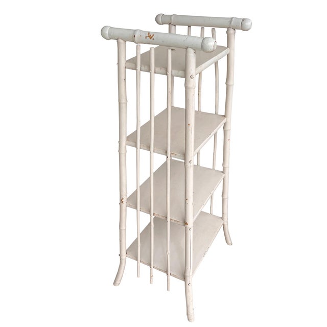 A charming antique bamboo étagère shelf in painted wood, embodying the timeless appeal of Hollywood Regency, Chinoiserie,...