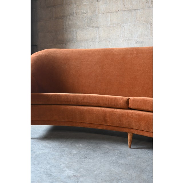 A curved Italian sofa by Ico Parisi. Gorgeous freshly upholstered burnt orange mohair fabric. Petite chic wooden legs....