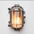 Old industrial outdoor wall lights, in cast aluminum, stripped, polished, with rounded mesh and transparent, thick and...