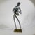 Very rare 1960s aluminum figure playing a brass saxophone. This modern minimalist figure is a most charming piece to add...