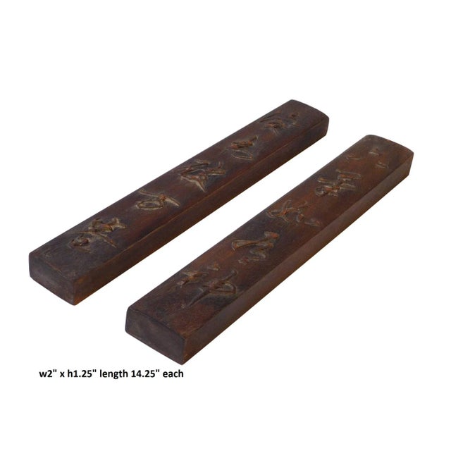 This is a pair of a natural wood paperweight in a rectangular shape with relief oriental Chinese characters pattern...