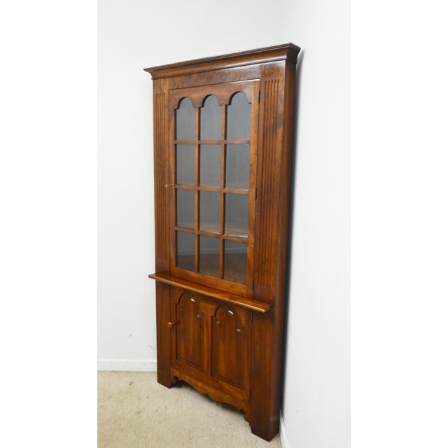 Corner Cabinet by Stickley. Store item # 549. It features adjustable shelves behind the glass door and interior lights.