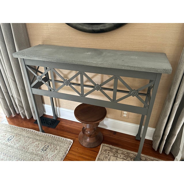 Stunning grey painted console table having chunky grey slate top and geometric fretwork on front with flower medallions....