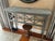 Stunning grey painted console table having chunky grey slate top and geometric fretwork on front with flower medallions....