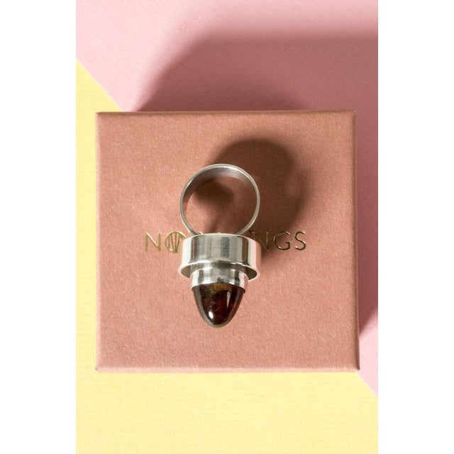 Cool, oversized silver ring from Niels Erik From, in a space age design building upwards. Bullet cut amber stone in a deep...