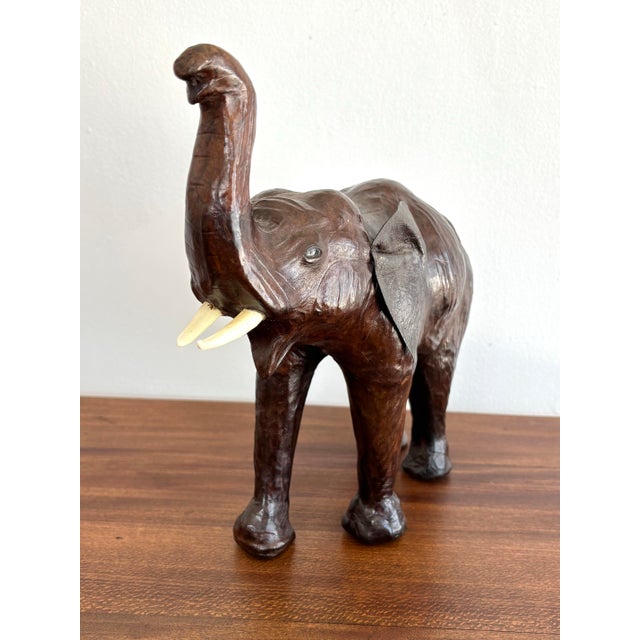 Brown leather-wrapped "lucky" elephant with an upward pointed trunk, which symbolizes prosperity and kindness. Adds a...