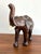 Brown leather-wrapped "lucky" elephant with an upward pointed trunk, which symbolizes prosperity and kindness. Adds a...