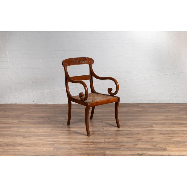 Brown Antique Javanese Wooden Armchair with Carved Back, Curving Arms and Rattan Seat For Sale - Image 8 of 13