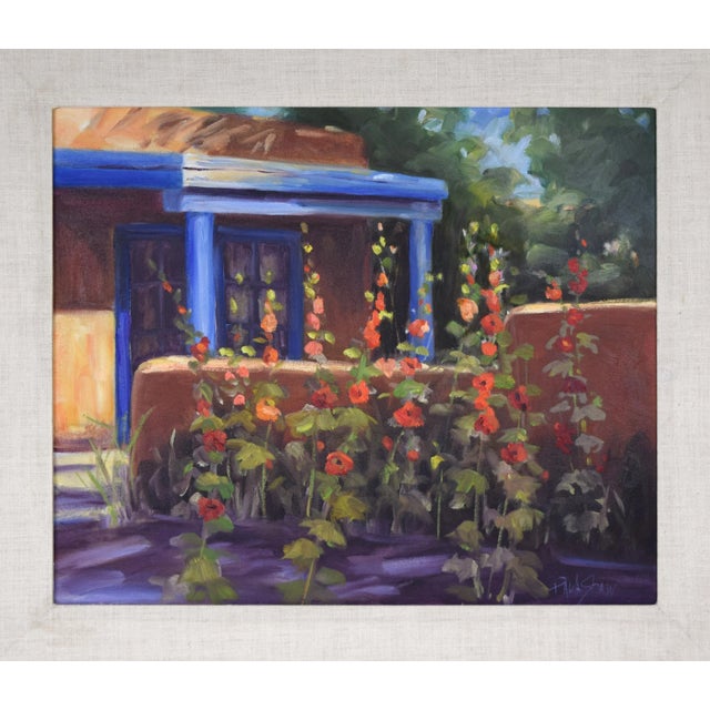 Original oil on canvas depicting an adobe house with holly hock or gladiolas flowers by Paula Shaw. Presented in an...