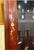 Two-piece solid rosewood china cabinet with mother-of-pearl plum blossom inlay and upturned cornice ends. Upper section...