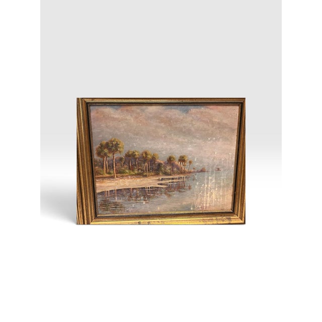 Charming and atmospheric antique Florida landscape painting dating to 1929, depicting a tranquil palm-lined shoreline...