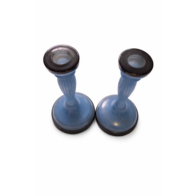 Elegant pair of circa 1930's glass candlesticks in a soft periwinkle blue hue, featuring a clean circular form and subtly...