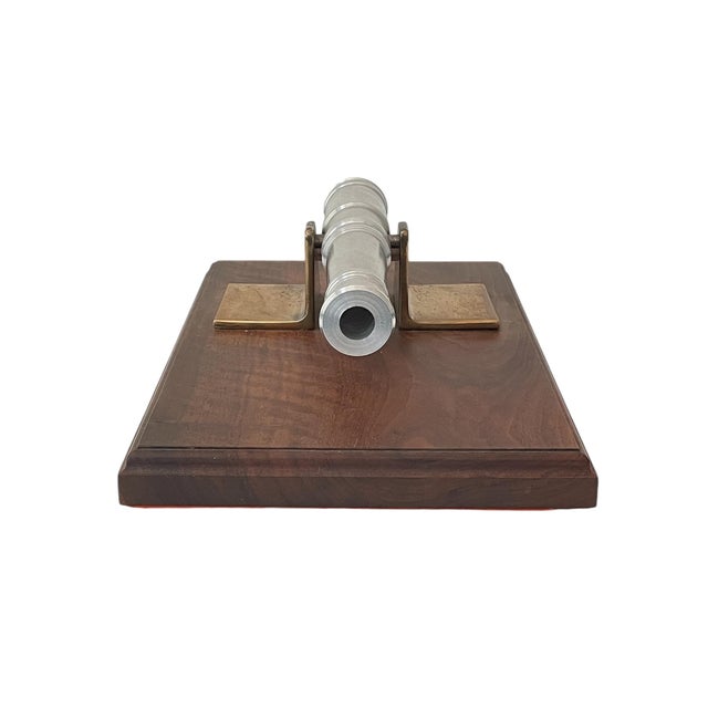 A fine and extraordinary handcrafted sculptural cannon on a substantial walnut wood base, the cannon is turned billet...