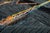 Neon on night: bright lines of color cutting through a dark, textured canvas. Vivid threads of sunset orange, blue, dusty...
