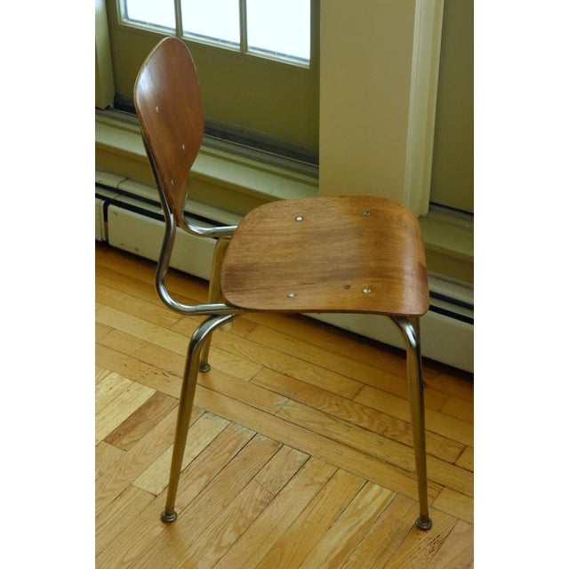 A vintage mid century modern side chair with a smart bent wood design on a chrome metal frame. In fair condition, has some...