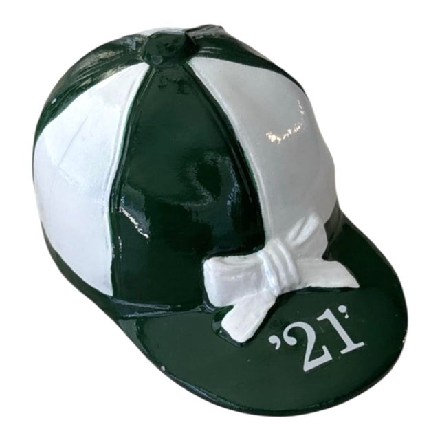 An original British racing green and white metal jockey helmet bottle opener. From the famed restaurant and prohibition...