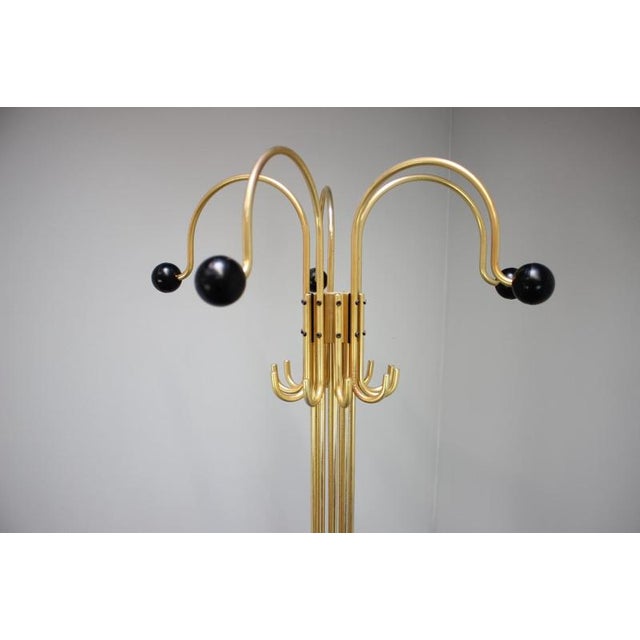 Elegant Italian floor coat rack manufactured during the 1980s, featuring a striking Postmodern design with polished brass...