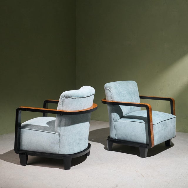 Pair of Art Deco lounge chairs produced in the 1940s in Italy. The chairs feature burlwood veneer on the armrests, which...