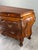 A louis xv style bombé commode in richly carved natural wood, featuring three drawers on the front. this elegant commode...